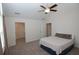 Bright bedroom with neutral walls, a ceiling fan, a walk-in closet, and plush carpet at 1000 Silver Summit Se Dr, Conyers, GA 30094