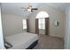 Bedroom featuring a large arched window, neutral carpet, and light walls offering a cozy retreat at 1000 Silver Summit Se Dr, Conyers, GA 30094