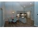 Bright kitchen with stainless steel appliances, gray cabinets, and adjacent dining area with modern lighting at 1000 Silver Summit Se Dr, Conyers, GA 30094