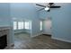 Bright living room with fireplace and adjacent sunroom, featuring wood-look floors at 1000 Silver Summit Se Dr, Conyers, GA 30094