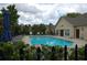 Outdoor swimming pool with lounge chairs, surrounded by mature trees and a secure fence at 1000 Silver Summit Se Dr, Conyers, GA 30094