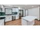 Modern kitchen features stainless steel appliances, white cabinetry, and an island with a white countertop at 2091 Parker Ranch Se Rd, Atlanta, GA 30316