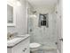 This bathroom features a sleek glass shower door and elegant granite countertops at 2711 Fairlane Dr, Atlanta, GA 30340