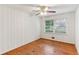 Empty bedroom featuring wooden paneling, hardwood floors and a ceiling fan at 2711 Fairlane Dr, Atlanta, GA 30340