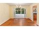 Open dining area with hardwood floors connecting to the kitchen and sunroom at 2711 Fairlane Dr, Atlanta, GA 30340