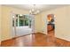 Bright dining room with hardwood floors leading to sunroom and kitchen at 2711 Fairlane Dr, Atlanta, GA 30340