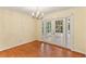 Dining room with hardwood floors, chandelier, and French doors to sunroom at 2711 Fairlane Dr, Atlanta, GA 30340