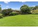 Landscaped front yard with lush green lawn and mature trees enhancing curb appeal at 2711 Fairlane Dr, Atlanta, GA 30340