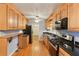 Kitchen featuring wooden cabinets, modern appliances, and hardwood floors at 2711 Fairlane Dr, Atlanta, GA 30340