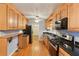 Kitchen boasts stainless steel appliances, hardwood floors, and wooden cabinets at 2711 Fairlane Dr, Atlanta, GA 30340