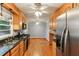 Open-concept kitchen with wood cabinets, stainless steel appliances and hardwood floors at 2711 Fairlane Dr, Atlanta, GA 30340