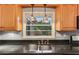 Kitchen sink with black countertops, stained-glass hanging lights, and wooden cabinets at 2711 Fairlane Dr, Atlanta, GA 30340