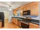 A well-lit kitchen with wood cabinets, stainless steel appliances, and a black countertop at 2711 Fairlane Dr, Atlanta, GA 30340
