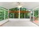 Bright sunroom with screened windows and a ceiling fan, perfect for enjoying the outdoors in comfort at 2711 Fairlane Dr, Atlanta, GA 30340