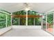 Bright sunroom with large windows overlooking lush greenery, plus ceiling fan and access to the deck at 2711 Fairlane Dr, Atlanta, GA 30340