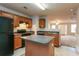 Efficient kitchen with wooden cabinetry, island, and views into the living area at 2850 Vining Ridge Ter, Decatur, GA 30034
