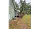 Back of house with wooden deck and stairs leading to large yard and green siding at 49 Patty Dr, Dallas, GA 30157