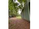 View of the backyard and the side of the house with green siding and a lush tree line at 49 Patty Dr, Dallas, GA 30157