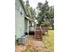 Back of house with wooden deck and stairs leading to large yard and green siding at 49 Patty Dr, Dallas, GA 30157