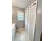Bathroom features a vanity with drawers, bi-fold closet and natural light from the window at 49 Patty Dr, Dallas, GA 30157