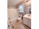 Bright bathroom features a white shower-tub combo, toilet, and vanity with a large mirror at 49 Patty Dr, Dallas, GA 30157