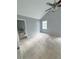 Bright bedroom featuring neutral carpet, vaulted ceiling with fan, window and ensuite bathroom at 49 Patty Dr, Dallas, GA 30157