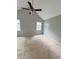 Bright bedroom with neutral carpet, ceiling fan, window and vaulted ceiling at 49 Patty Dr, Dallas, GA 30157