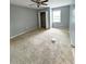 Spacious bedroom with neutral carpet, ceiling fan, window, and walk-in closet at 49 Patty Dr, Dallas, GA 30157
