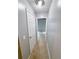 Hallway with neutral carpet leading to a bedroom with a ceiling fan and natural light at 49 Patty Dr, Dallas, GA 30157