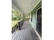 Covered porch with stained wood flooring at 49 Patty Dr, Dallas, GA 30157