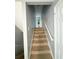 Carpeted stairs leading to the upper level of the home at 49 Patty Dr, Dallas, GA 30157