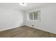 Bedroom with new light fixture, wood-look floors, and large window providing natural light at 100 Biscayne Nw Dr # C1, Atlanta, GA 30309