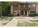 Charming townhouse featuring brick and stone accents, complemented by mature landscaping and a welcoming entrance at 100 Biscayne Nw Dr # C1, Atlanta, GA 30309