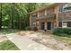 Charming townhouse featuring brick and stone accents, complemented by mature landscaping and a welcoming entrance at 100 Biscayne Nw Dr # C1, Atlanta, GA 30309