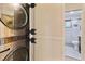 Stackable washer and dryer situated in a laundry area adjacent to the bathroom at 100 Biscayne Nw Dr # C1, Atlanta, GA 30309