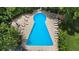 Aerial view of uniquely shaped pool with lounge chairs, tables and lush green landscaping at 100 Biscayne Nw Dr # C1, Atlanta, GA 30309