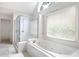 Large bathroom with a soaking tub, walk-in shower, and natural light from multiple windows at 2613 Winterthur Main Nw, Kennesaw, GA 30144