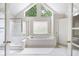 Bright bathroom with a shower and a soaking tub under large windows at 2613 Winterthur Main Nw, Kennesaw, GA 30144