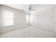 Bright bedroom with two windows, neutral walls, and a ceiling fan at 2613 Winterthur Main Nw, Kennesaw, GA 30144