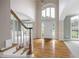 Bright foyer with hardwood floors, a staircase, and a view into other rooms at 2613 Winterthur Main Nw, Kennesaw, GA 30144