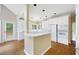 Bright kitchen featuring a breakfast bar and access to the back patio at 2613 Winterthur Main Nw, Kennesaw, GA 30144