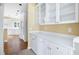 Bright kitchen features white cabinets, stainless steel appliances, and hardwood floors at 2613 Winterthur Main Nw, Kennesaw, GA 30144