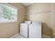 Laundry room with washer, dryer, and a window with natural light at 2613 Winterthur Main Nw, Kennesaw, GA 30144