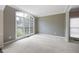 Carpeted Living room with a large window providing natural light at 2613 Winterthur Main Nw, Kennesaw, GA 30144