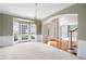 Elegant living room with bay windows, crown molding, and a view of the front yard at 2613 Winterthur Main Nw, Kennesaw, GA 30144