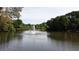 Scenic pond with a water fountain and surrounding greenery, offering a peaceful view at 2613 Winterthur Main Nw, Kennesaw, GA 30144