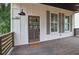Inviting front porch with wood railing, a welcome mat, and stylish lighting, enhancing the home's curb appeal at 826 Gaston Sw St, Atlanta, GA 30310
