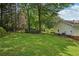 A spacious backyard with manicured lawn with a picnic table and an outdoor sofa set for relaxation at 1501 Memory Se Ln, Smyrna, GA 30080