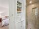Bathroom featuring a walk-in shower with tiled walls and a linen closet with storage space at 1501 Memory Se Ln, Smyrna, GA 30080