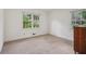 A bright bedroom features neutral tones, carpeted floors, and bright natural light from windows at 1501 Memory Se Ln, Smyrna, GA 30080